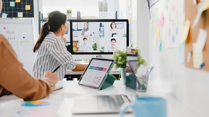 asia-businesspeople-using-desktop-talk-colleagues-discussing-business-brainstorm-about-plan-video-call-meeting-new-normal-office-700x394